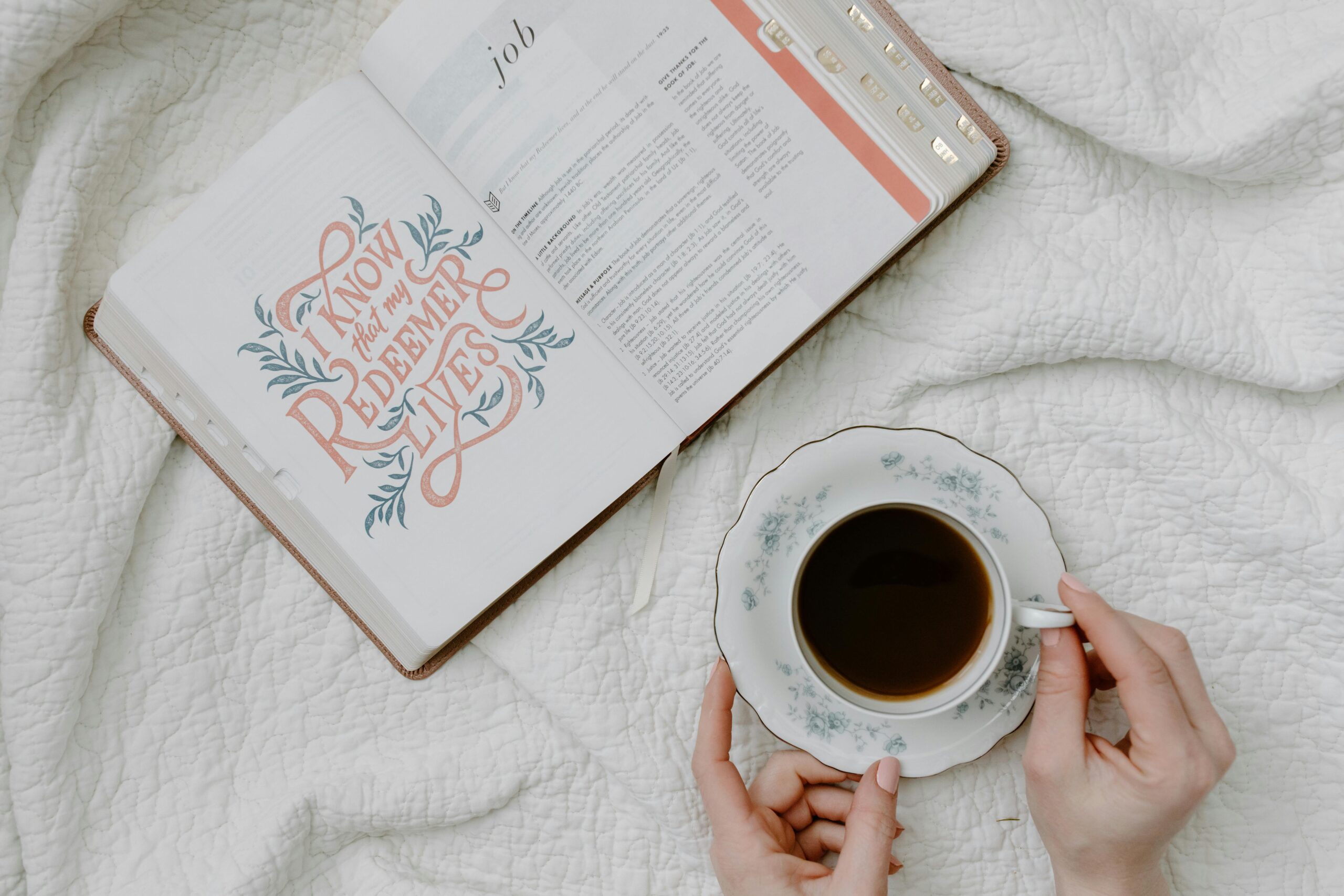 An open Bible with a quote and coffee, embodying a serene morning routine.